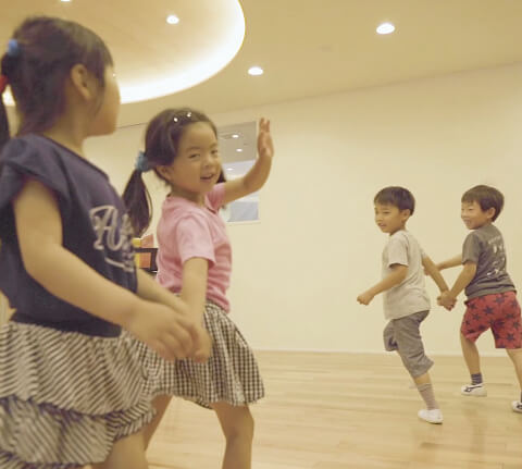 リズムに乗って運動する子どもの写真